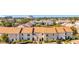 Condo building with tan exterior, brown roof and lush landscaping, aerial view at 13600 Egret Blvd # 204K, Clearwater, FL 33762