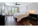 Main bedroom with a queen-size bed, dark hardwood floors, and large windows at 13600 Egret Blvd # 204K, Clearwater, FL 33762