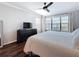 Main bedroom with queen bed, dark hardwood floors, and large window with blinds at 13600 Egret Blvd # 204K, Clearwater, FL 33762