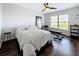 Cozy bedroom with a queen-size bed, dark hardwood floors, and large window at 13600 Egret Blvd # 204K, Clearwater, FL 33762