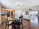 Open concept dining room and kitchen, featuring hardwood floors and a round dining table at 13600 Egret Blvd # 204K, Clearwater, FL 33762