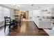 Living room and dining area with hardwood floors, a light-grey sectional sofa, and a dark-wood dining table at 13600 Egret Blvd # 204K, Clearwater, FL 33762