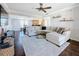Open living room with hardwood floors, sectional sofa, and view into dining area at 13600 Egret Blvd # 204K, Clearwater, FL 33762