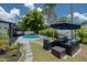 Inviting backyard with pool, patio furniture, and lush landscaping at 14040 Cascade Ln, Tampa, FL 33618