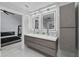 Modern bathroom with double vanity, marble floors and LED backlit mirrors at 14040 Cascade Ln, Tampa, FL 33618