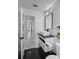 Modern bathroom with black and white marble tile, floating vanity, and large mirror at 14040 Cascade Ln, Tampa, FL 33618