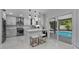 Modern kitchen with white cabinets, marble counters, and stainless steel appliances at 14040 Cascade Ln, Tampa, FL 33618