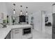 Modern kitchen with island, white cabinets, and marble countertops at 14040 Cascade Ln, Tampa, FL 33618