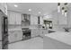 Modern white kitchen with stainless steel appliances and marble flooring at 14040 Cascade Ln, Tampa, FL 33618