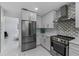 Modern kitchen with stainless steel appliances and white cabinets at 14040 Cascade Ln, Tampa, FL 33618