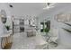 Modern white kitchen with marble floors, stainless steel appliances, and breakfast bar at 14040 Cascade Ln, Tampa, FL 33618