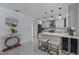 Modern kitchen features white cabinets, marble countertops and breakfast bar at 14040 Cascade Ln, Tampa, FL 33618