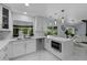 Modern kitchen with white cabinets, marble countertops and island at 14040 Cascade Ln, Tampa, FL 33618