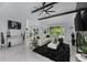 Bright living room with white sectional sofa, marble floors, and pool view at 14040 Cascade Ln, Tampa, FL 33618