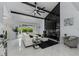 Modern living room with black marble fireplace, vaulted ceiling, and white leather sectional at 14040 Cascade Ln, Tampa, FL 33618