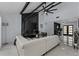 Open living room with black marble fireplace, white sectional sofa, and high ceilings at 14040 Cascade Ln, Tampa, FL 33618