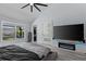 Main bedroom with king-size bed, large TV and fireplace at 14040 Cascade Ln, Tampa, FL 33618