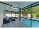 Cozy screened-in porch overlooking the pool and backyard at 14040 Cascade Ln, Tampa, FL 33618
