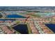 Aerial view of the community with scenic ponds and community pool and new homes at 17014 Clear Cork Dr, Wimauma, FL 33598