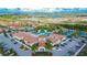 Aerial view of the community clubhouse with a resort-style pool, tennis courts, and ample parking at 17014 Clear Cork Dr, Wimauma, FL 33598