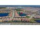 Stunning aerial view of a well-planned community, showcasing many homes with beautiful landscaping around a lake at 17014 Clear Cork Dr, Wimauma, FL 33598