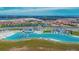 Aerial view of the lagoon with many activities, neighborhood and new construction in background at 17014 Clear Cork Dr, Wimauma, FL 33598
