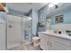 Bathroom with a glass-enclosed shower, blue accents, and a modern vanity at 17014 Clear Cork Dr, Wimauma, FL 33598