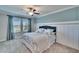 Calm bedroom with a lake view, light blue walls, and matching curtains for a relaxing space at 17014 Clear Cork Dr, Wimauma, FL 33598