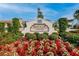 Medley Clubhouse entrance featuring beautifully landscaped grounds and vibrant flowerbeds at 17014 Clear Cork Dr, Wimauma, FL 33598