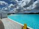 Beautiful community pool with crystal clear water and a sandy beach area, perfect for a day of relaxation and fun at 17014 Clear Cork Dr, Wimauma, FL 33598