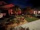 Well-maintained lawn with a variety of plants, flowerbed, and shrubbery with a paved pathway leading up to the door at 17014 Clear Cork Dr, Wimauma, FL 33598