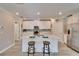 Beautiful kitchen with white cabinetry, stainless steel appliances, and island with barstool seating at 17014 Clear Cork Dr, Wimauma, FL 33598