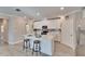 Modern kitchen with white cabinetry, stainless steel appliances, and a center island with seating at 17014 Clear Cork Dr, Wimauma, FL 33598