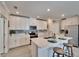 Bright kitchen with stainless steel appliances, a center island with barstool seating and lots of cabinets at 17014 Clear Cork Dr, Wimauma, FL 33598
