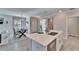 Bright kitchen area with a large island, stainless steel appliances, and seamless access to the dining area at 17014 Clear Cork Dr, Wimauma, FL 33598
