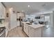 Kitchen with a large island, stainless appliances and open concept to the living and dining areas at 17014 Clear Cork Dr, Wimauma, FL 33598