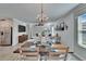 Open-concept living and dining area featuring a modern chandelier and stylish decor at 17014 Clear Cork Dr, Wimauma, FL 33598