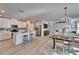 Spacious open floor plan with a kitchen island, stainless appliances, living room and dining area at 17014 Clear Cork Dr, Wimauma, FL 33598