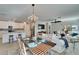 Open-concept floorplan with kitchen island, dining area and living room with view of the lake at 17014 Clear Cork Dr, Wimauma, FL 33598