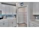 Well-organized pantry with white cabinets, quartz counters, stylish backsplash, and adjustable wire shelving at 17014 Clear Cork Dr, Wimauma, FL 33598
