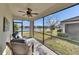 Enjoy outdoor living on this screened patio with lovely lake views and comfortable seating at 17014 Clear Cork Dr, Wimauma, FL 33598