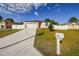 Single story home with white exterior, two-car garage and driveway at 2252 Maximilian Ave, Spring Hill, FL 34609