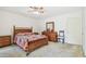 This bedroom has a wooden bed frame and dresser with neutral carpet at 2381 Ecuadorian Way # 33, Clearwater, FL 33763