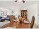 Dining area with a wooden table set with place settings and a lovely view into the living room at 2381 Ecuadorian Way # 33, Clearwater, FL 33763