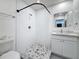 Updated bathroom with white tile, walk-in shower, and new vanity at 2427 10Th S Ave, St Petersburg, FL 33712