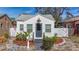 Charming white cottage with gray door, landscaping, and fenced yard at 2427 10Th S Ave, St Petersburg, FL 33712