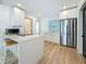 Modern kitchen with island, stainless steel appliances, and white cabinets at 2427 10Th S Ave, St Petersburg, FL 33712
