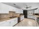 Spacious kitchen with white cabinets, tile floors, and stainless steel appliances at 263 42Nd Ne Ave, St Petersburg, FL 33703