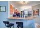 Modern kitchen with granite countertops, stainless steel appliances, and breakfast bar at 2738 Via Tivoli # 220B, Clearwater, FL 33764