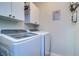 Convenient laundry room with washer, dryer, and cabinets at 2738 Via Tivoli # 220B, Clearwater, FL 33764